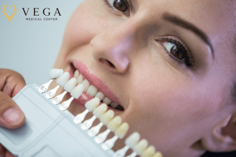 Dentist checking a veneer shade against a patient's teeth